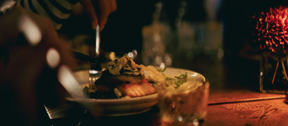Fine dining dish being finished with sauce